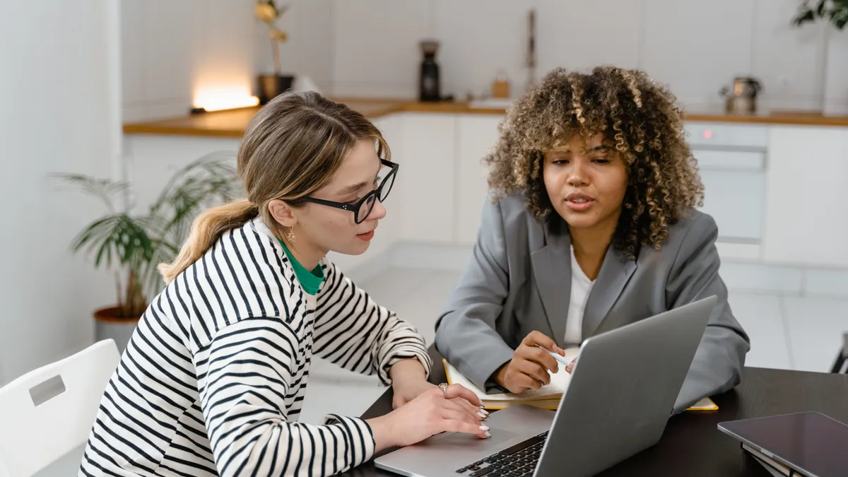 Two employees work together in an office