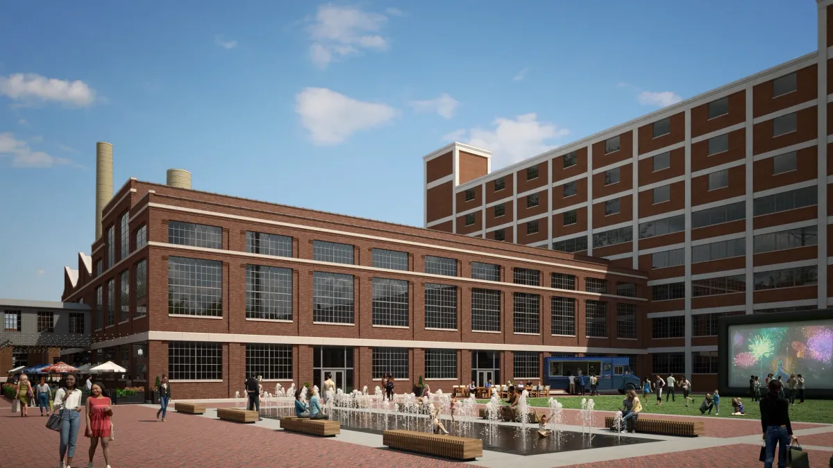 A render of a new building, covered in brown brick, amid a blue sky. People walk around it.