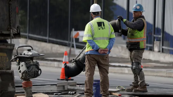 Workers make repairs to an underground pipe