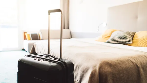 Suitcase sitting in hotel room