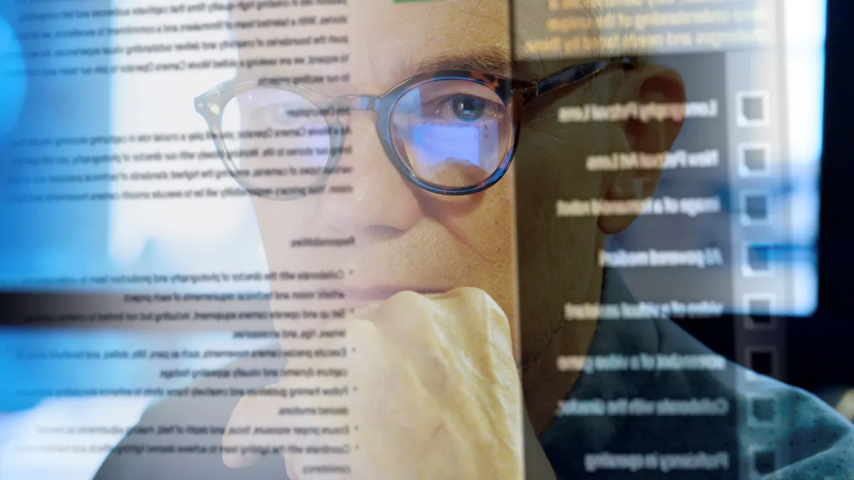 Photo of worker looking at a chatbot on screen