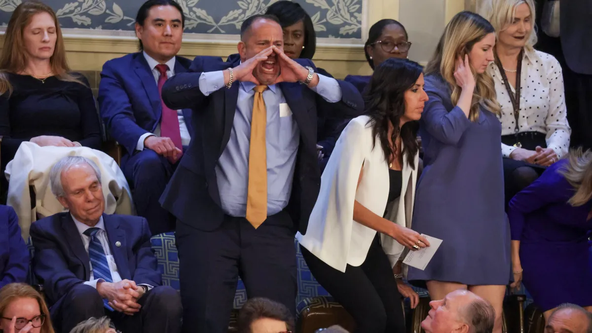 A person yells in the House chamber at the U.S. Capitol.