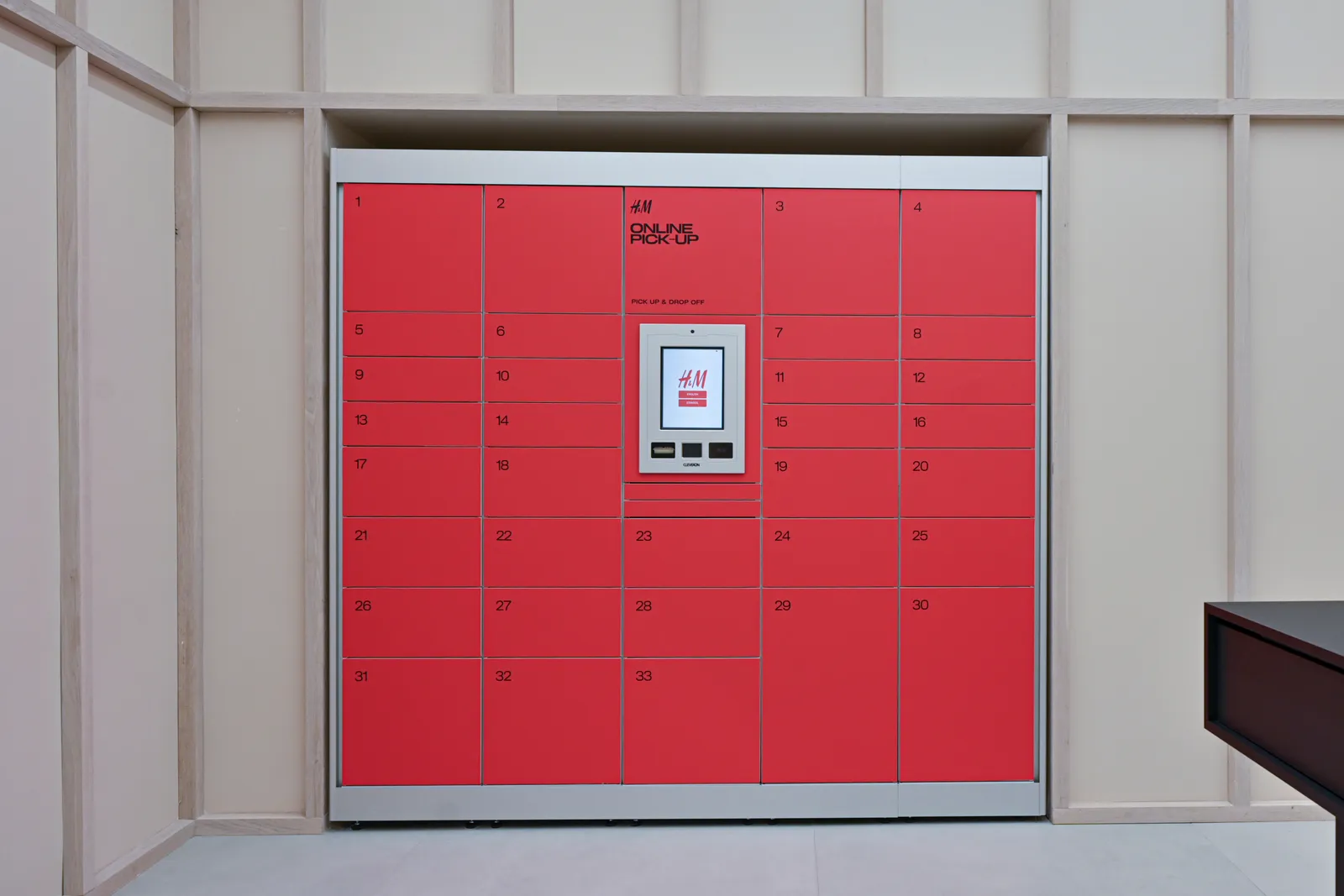 A wall of red pickup lockers for online orders at an H&amp;M store in SoHo.