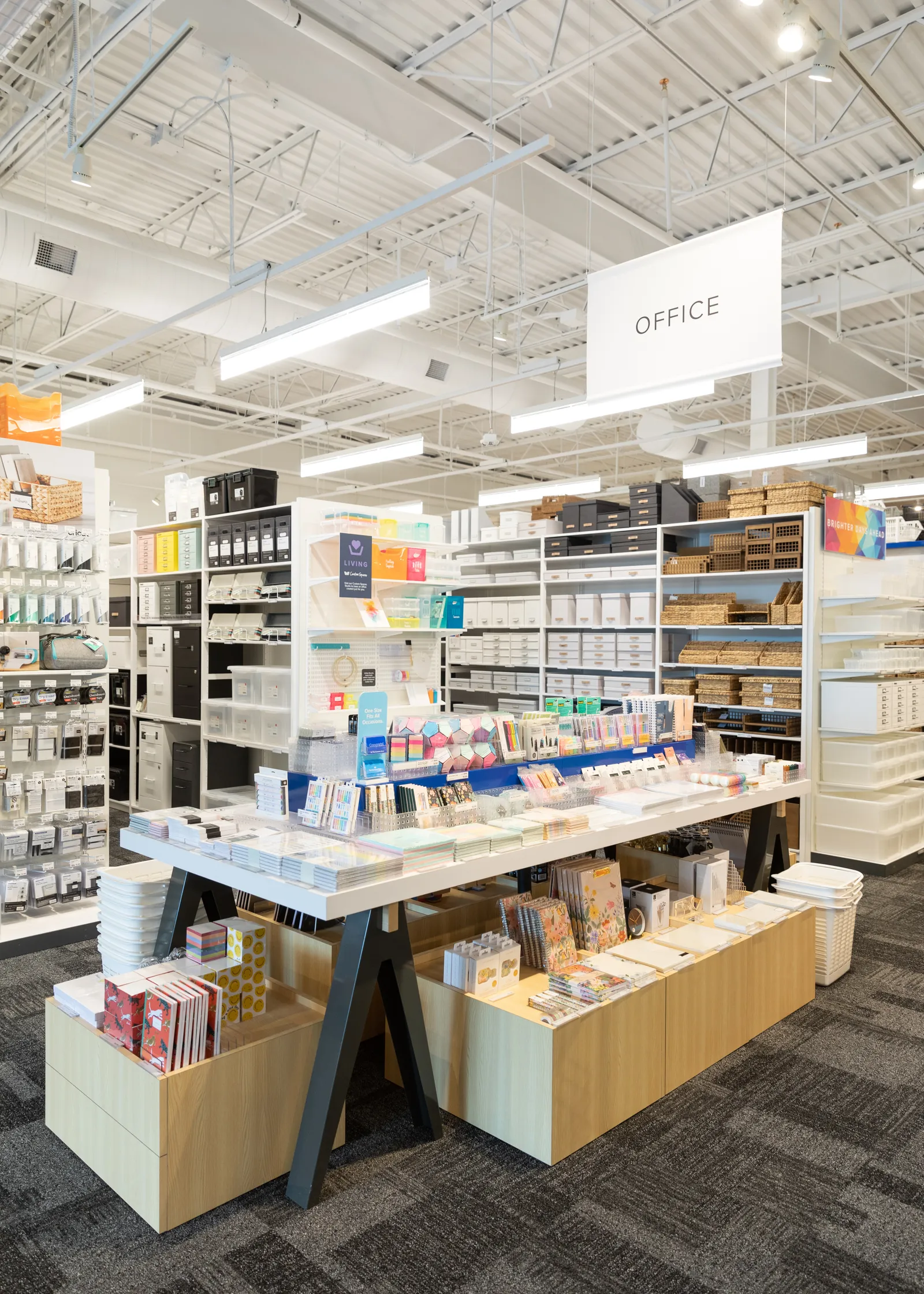 A display of office products on a table inside of a Container Store.