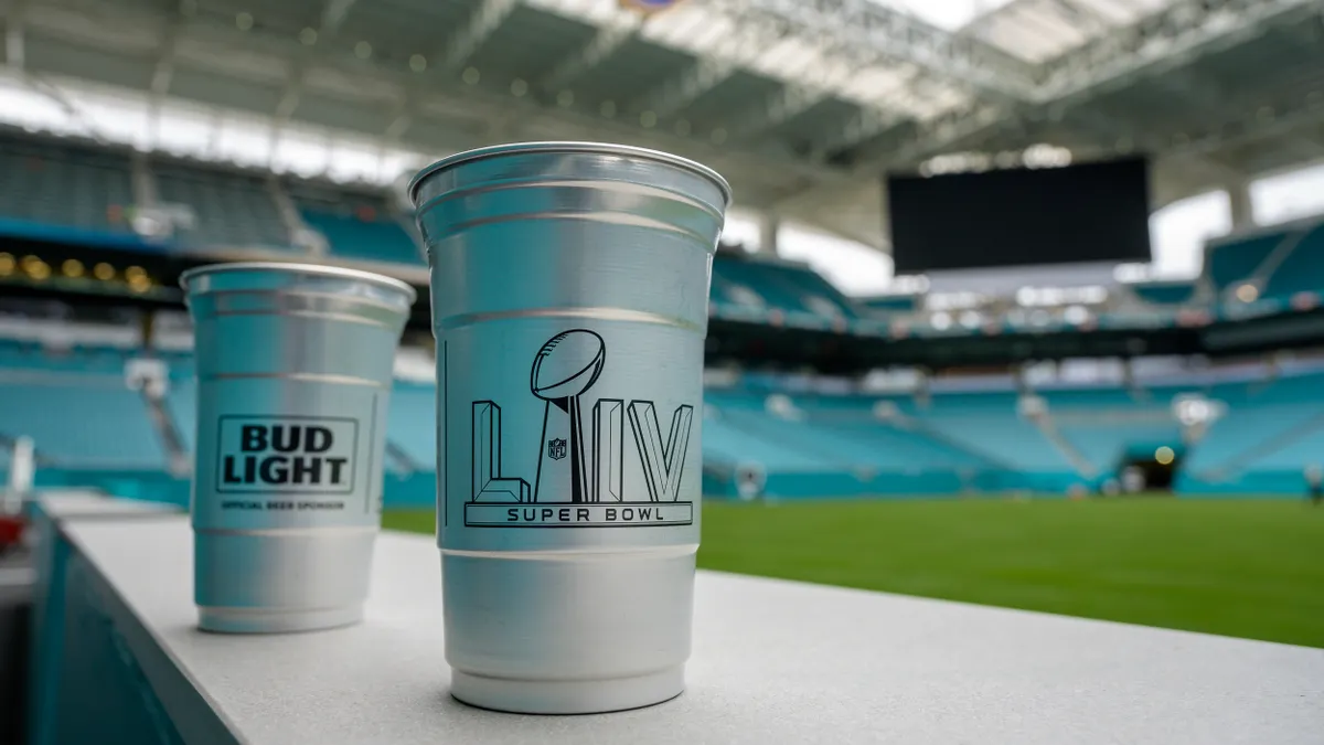 Silver aluminum cups alongside empty stadium field