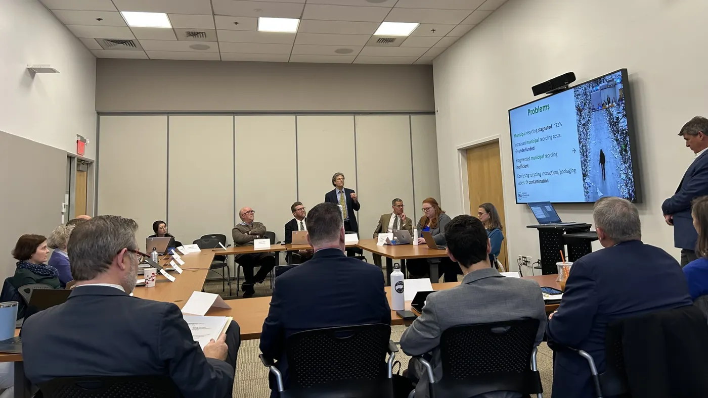 A room full of people seated, with two standing, in a conference room at the MassDEP offices.