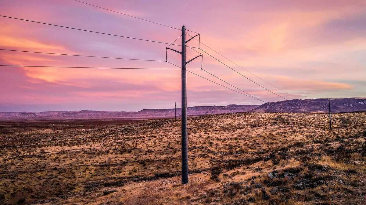 Pole in a flat desert area.