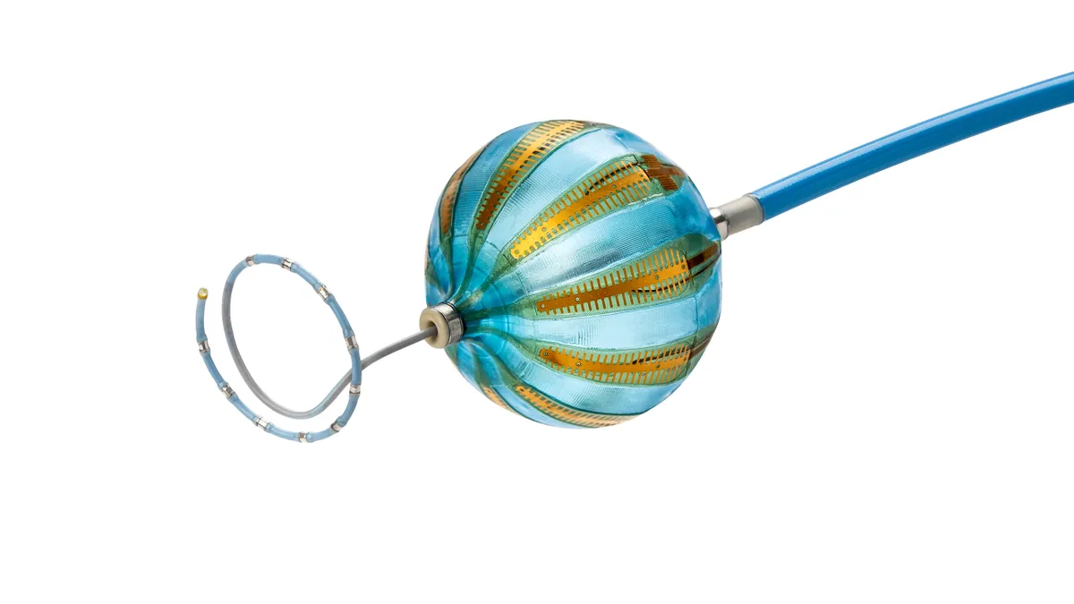 A close up of a blue catheter with a blue and copper balloon at the end.