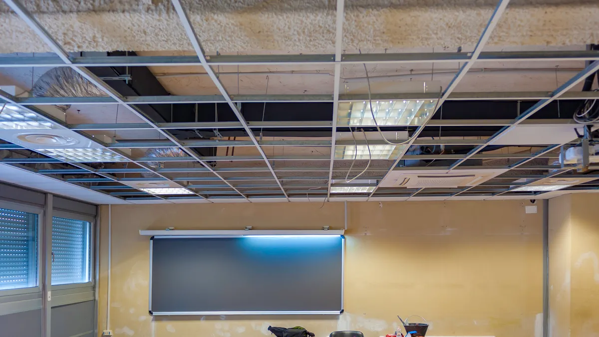 A gypsum ceiling in a classroom is replaced.