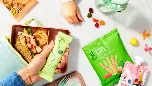 Hands holding snacks.
