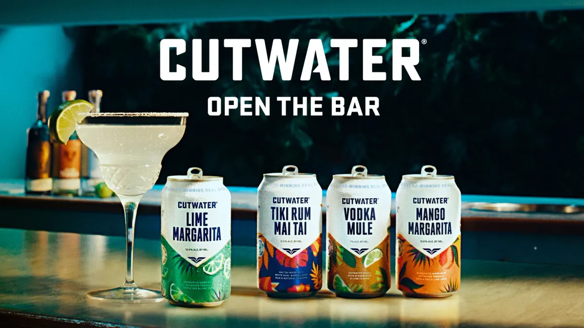 Several cans of Cutwater canned cocktails sit on a counter.