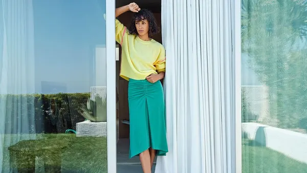 A model wears brightly colored Sundry clothing.