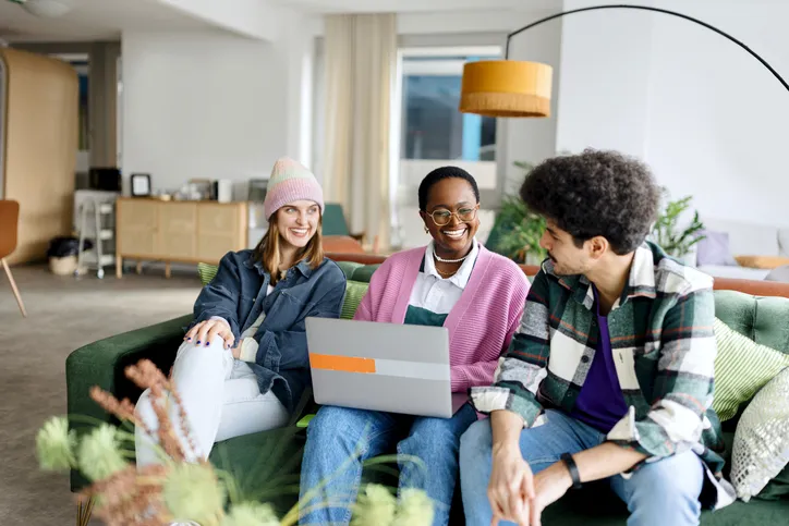 three people sitting on couch