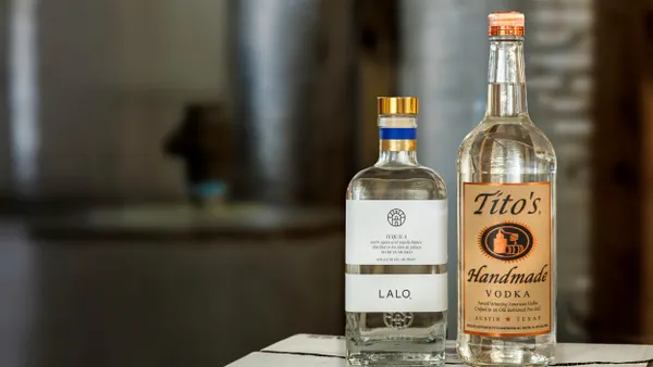 A bottle of Lalo Tequila is next to a bottle of Tito's Handmade Vodka in a product shot.