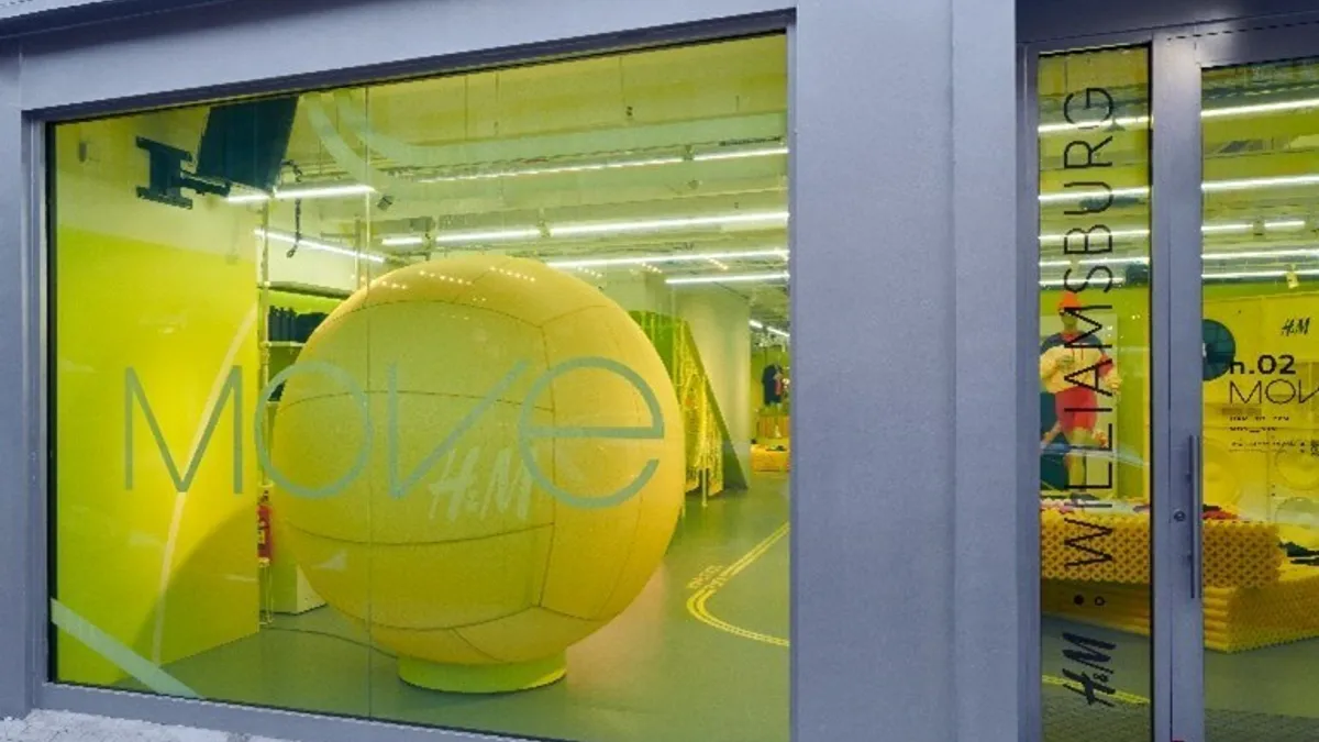 An H&M storefront with a yellow volleyball in the window.