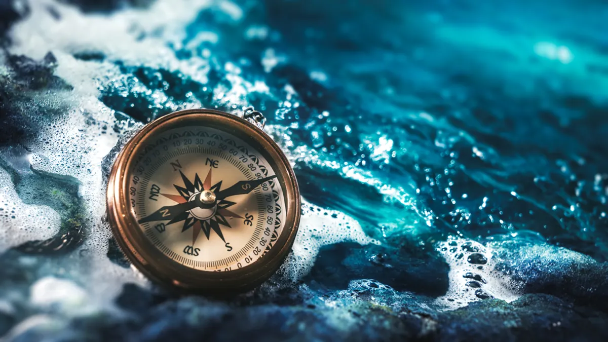 Compass on rocks with a dark sky
