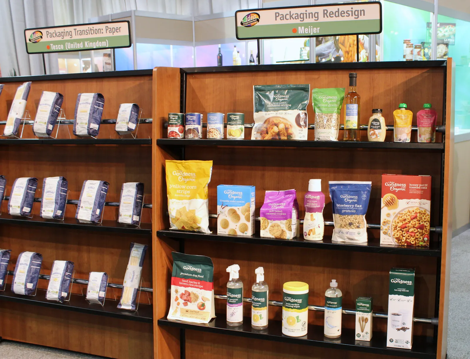 Displays at a trade show feature food packaging from grocers Tesco and Meijer.