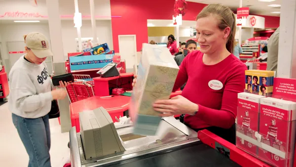 A Target cashier checks out a customer