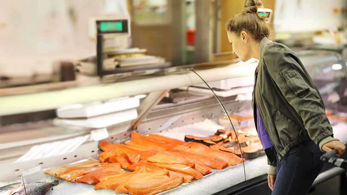 Person looking at fresh fish in the grocery store