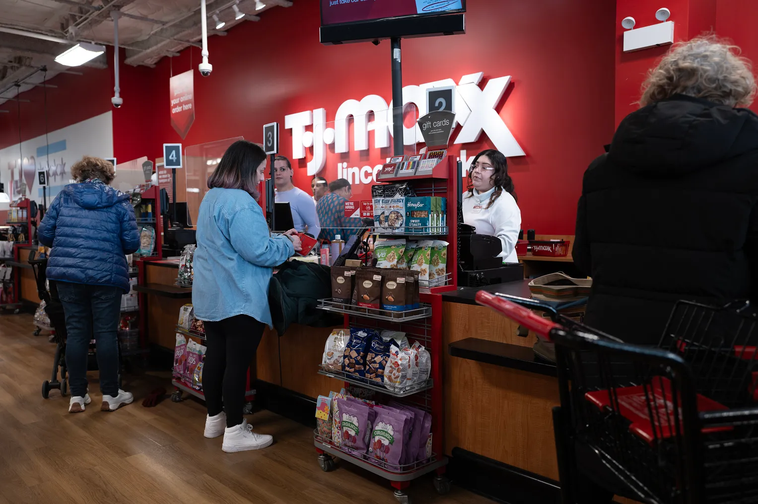 Customers make purchases at a T. J. Maxx store.