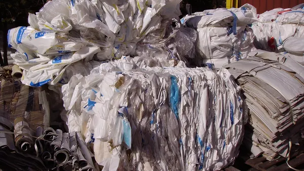 Industrial plastic packaging and pipes is stuffed into a container