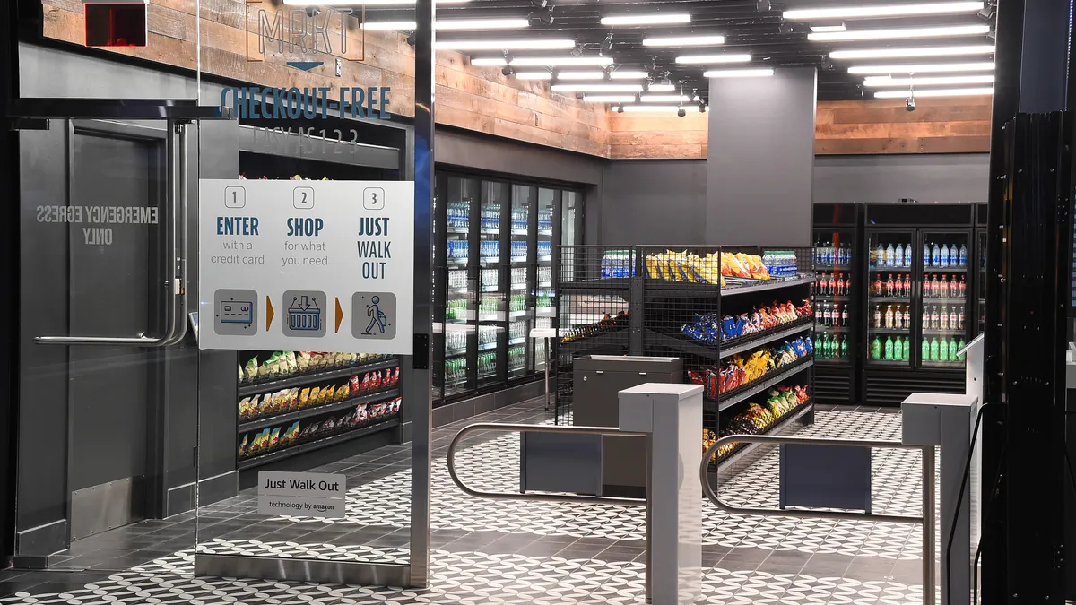 Entrance of of a convenience store with shelves and refrigerators displaying snacks and beverages.