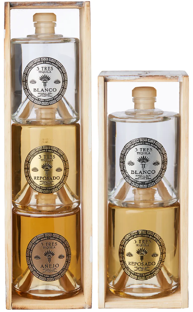 Bottles of 3 Tres Tequila that are stacked on top of each other, one stack with three bottles and the other with two.