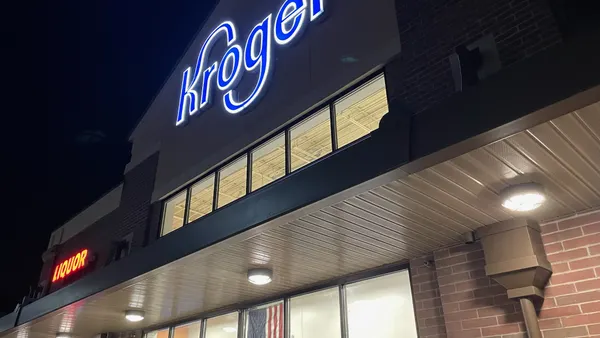 Exterior of a grocery store at night.