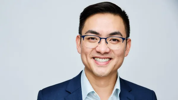 A smiling man in a blue suit.