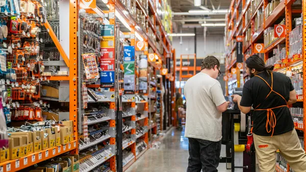 An employee assists a customer at The Home Depot store.