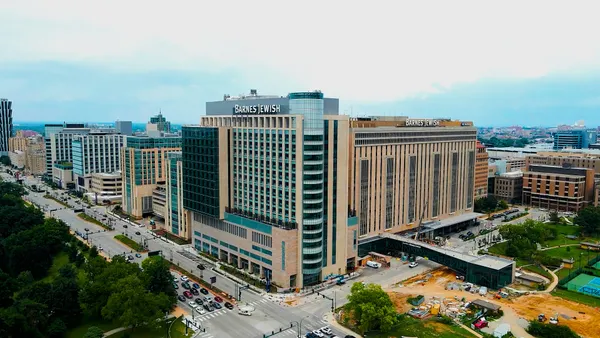 A shot from afar of a large building that occupies a corner. It says "Barnes Jewish" along the top.