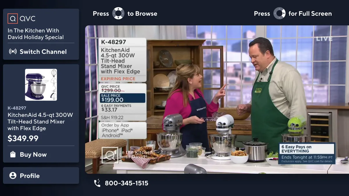 In a screenshot, two people demonstrate a kitchen stand mixer during a QVC segment