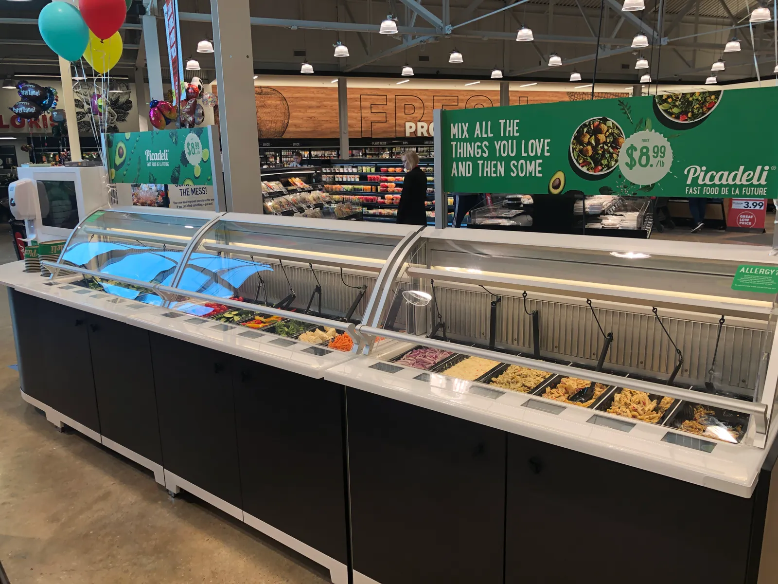 A tech-driven salad bar in a grocery store.