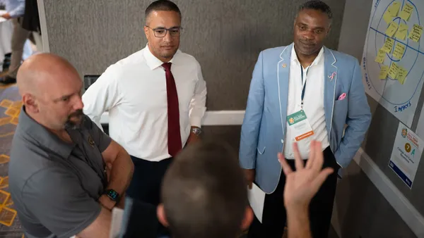 Four people having a discussion while standing