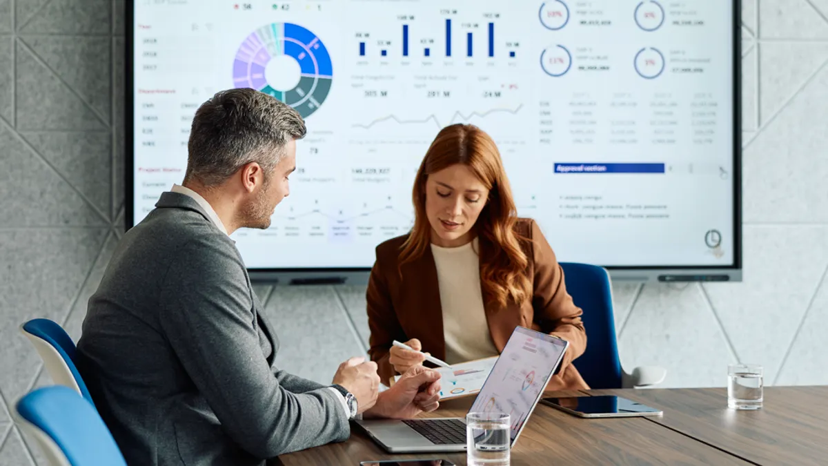 Business people discussing financial data in meeting room