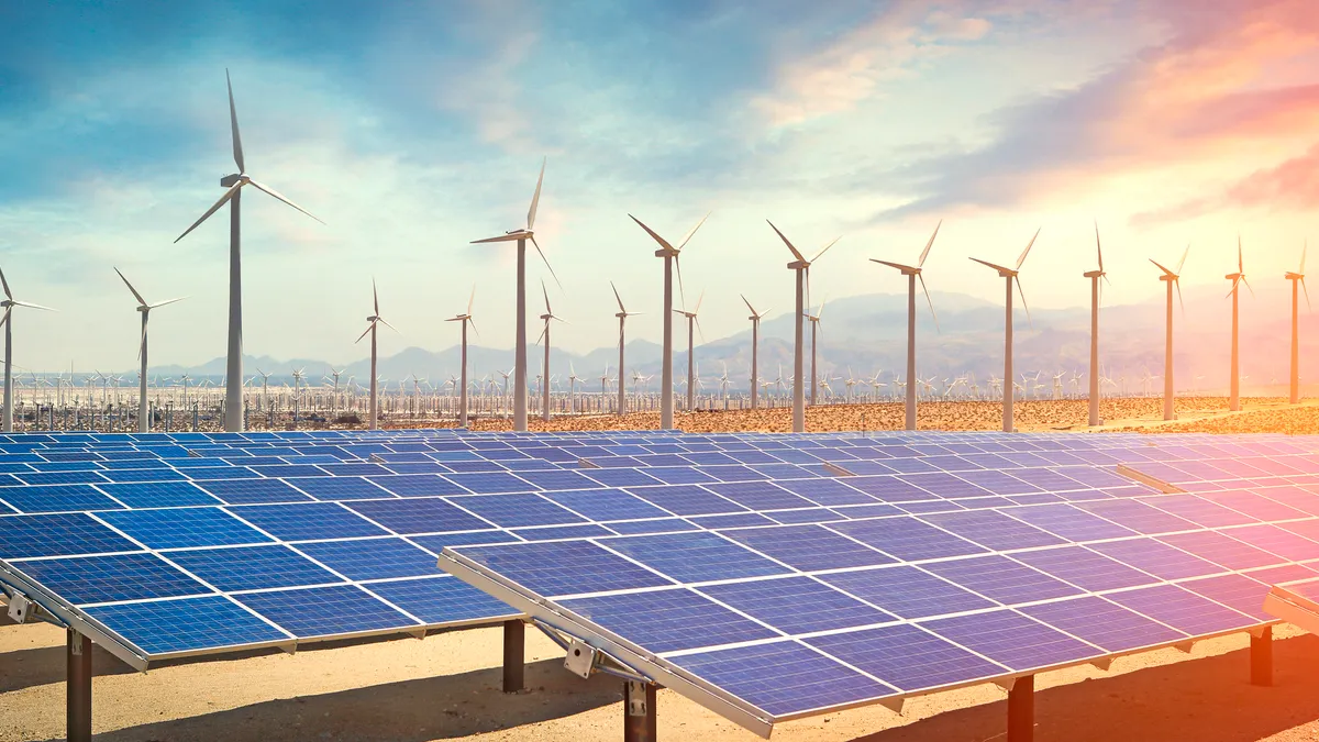 Solar panels and wind turbines in the desert producing renewable energy.