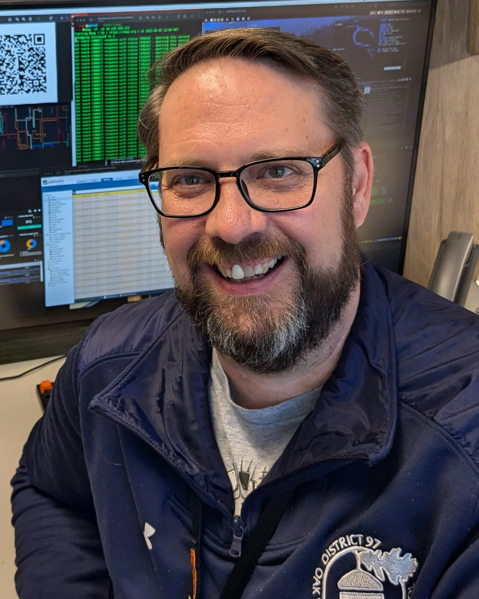 Will Brackett sits at his desk in front of a computer monitor.