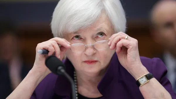 Treasury Secreatry Janet Yellen peers behind her glasses on Capitol Hill.