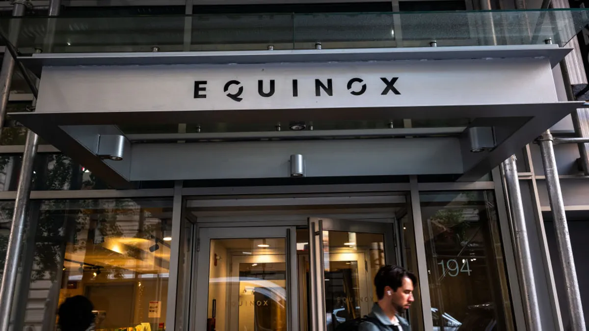 Pedestrians walk past Equinox fitness club center in New York City