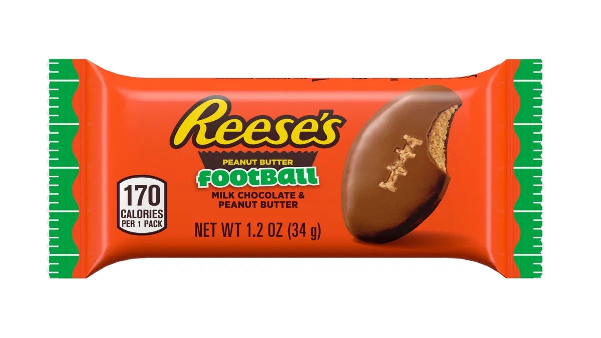 A product shot of a Reese's variant featuring football-shaped candies against a white background.