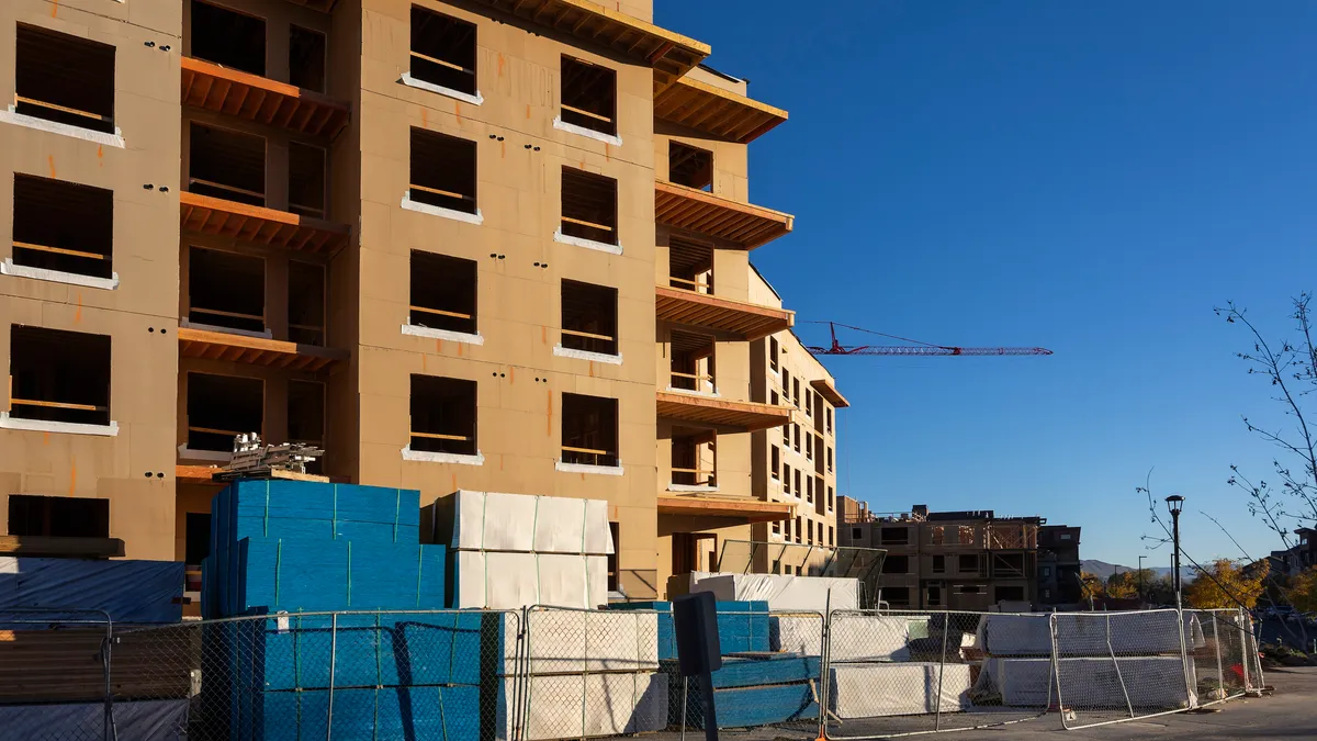 Empty housing construction site with crane in background