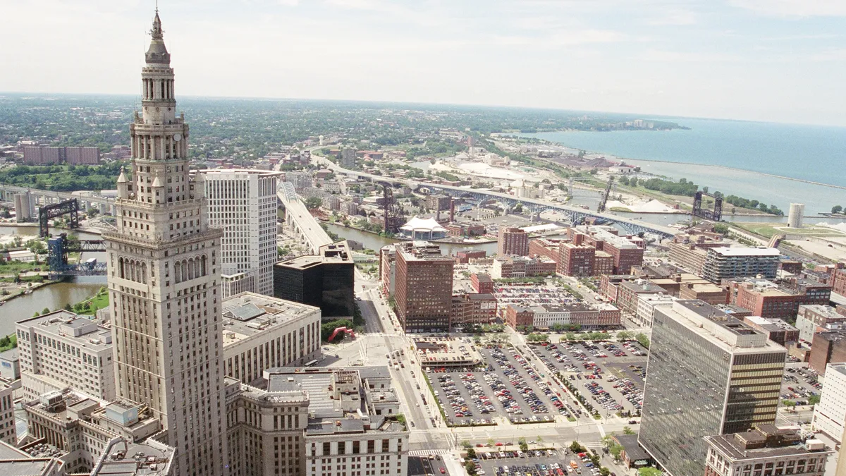 a skyline view of cleveland, ohio with many buildings and a shoreline of a lake