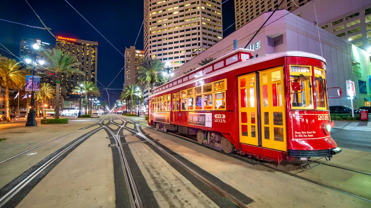 Red streetcar of New Orleans moving through city streets