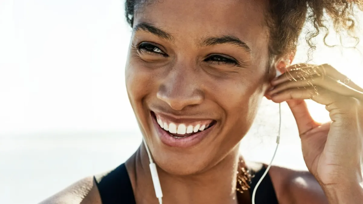 Image of woman listening to music via earphones