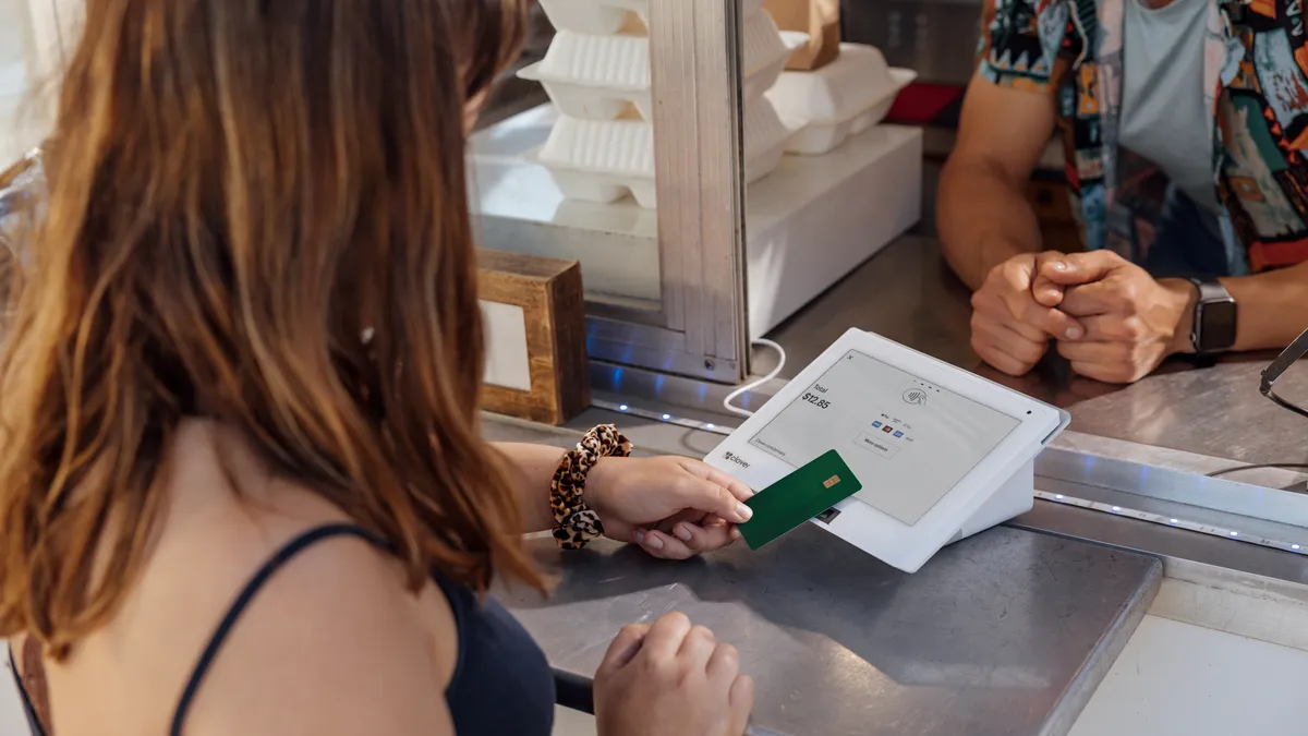 A customer pays using a Clover device