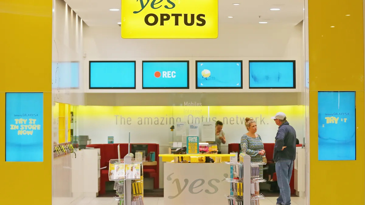 Optus signage displayed at a store in Melbourne, Australia.