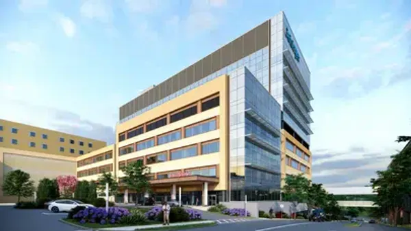 A rendering of a large building in the background, with a parking lot at the front.