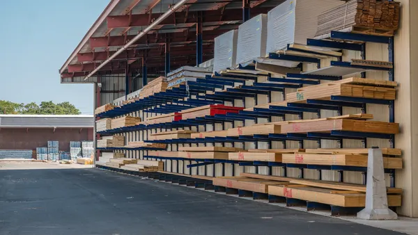 Stacks of lumber being stored in a at a lumber yard.