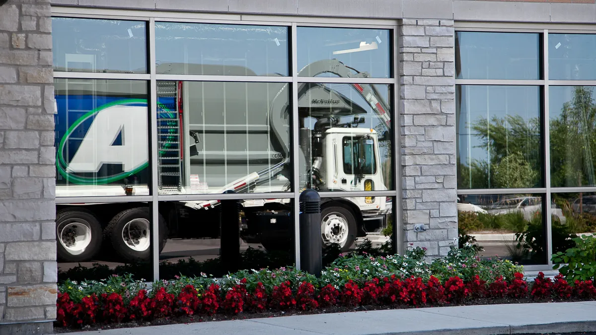 Advanced Disposal Services truck reflected in window