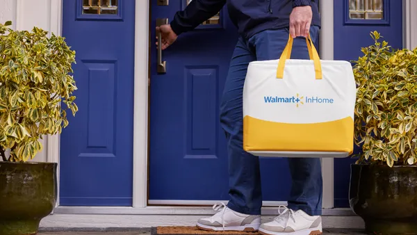 A worker drops off a Walmart delivery at a doorstep